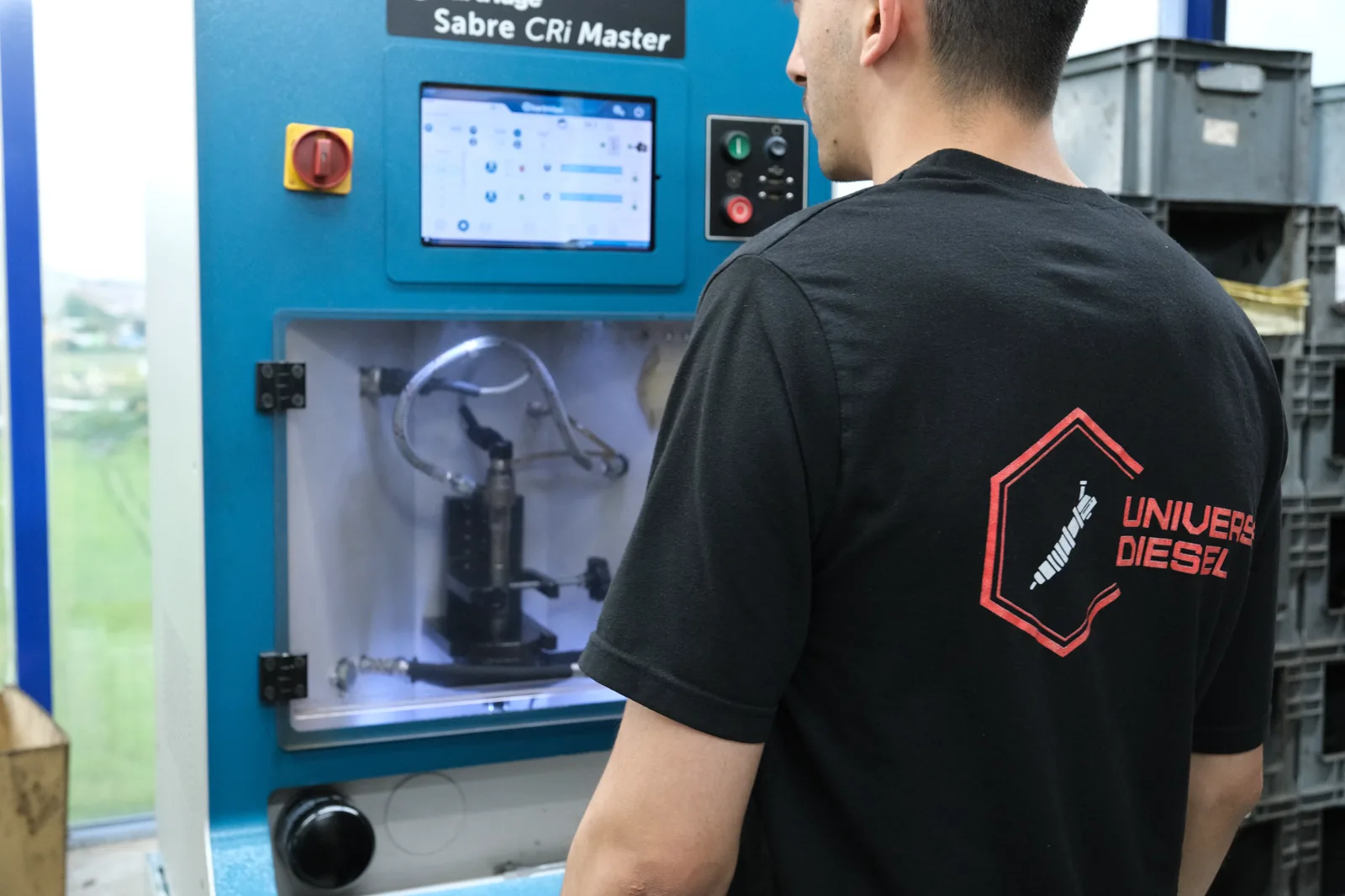 Diesel technician operating a common-rail injector test bench